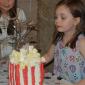Caroline blows out the candle.